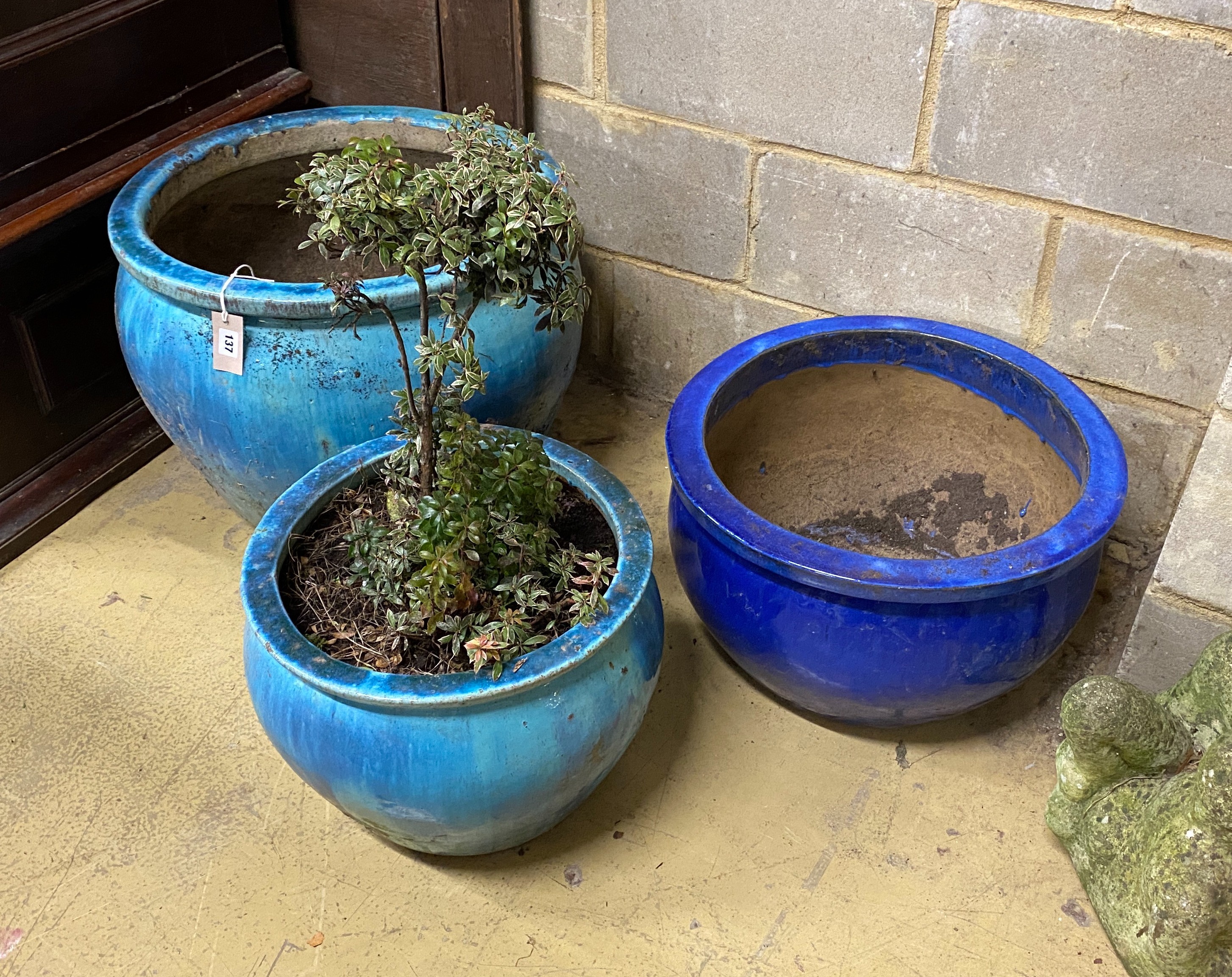 Three circular glazed earthenware garden planters, largest diameter 54cm, height 46cm